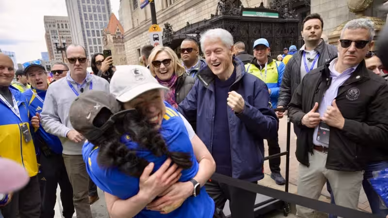 Chelsea Clinton hugs her parents after finishing Boston Marathon